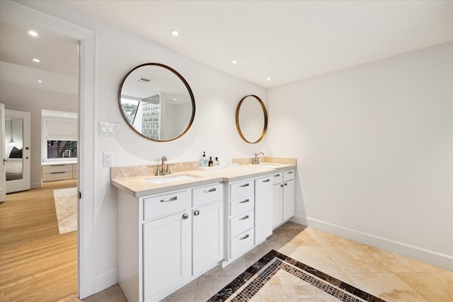 bathroom with hardwood / wood-style flooring and vanity