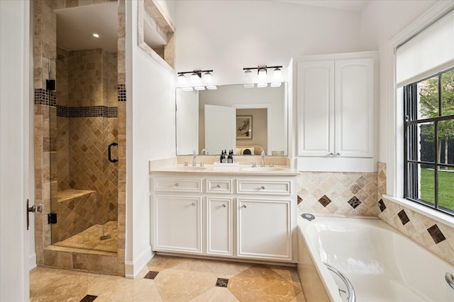 bathroom featuring vanity and separate shower and tub