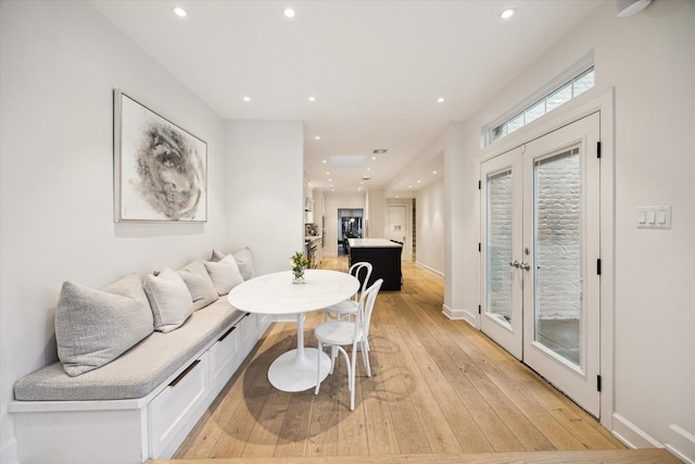 dining area with french doors and light wood-type flooring