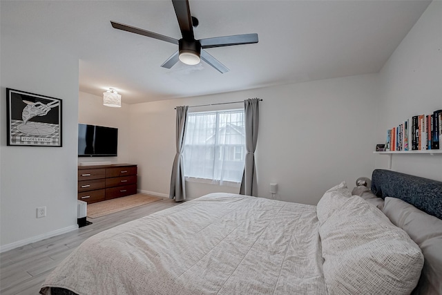 bedroom with ceiling fan and light wood-type flooring