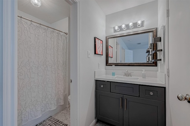 full bathroom with vanity, shower / bath combo, and toilet