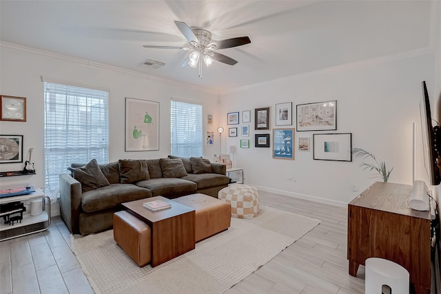 living room with crown molding, ceiling fan, and light wood-type flooring