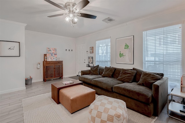 living room with ceiling fan, ornamental molding, and light wood-type flooring