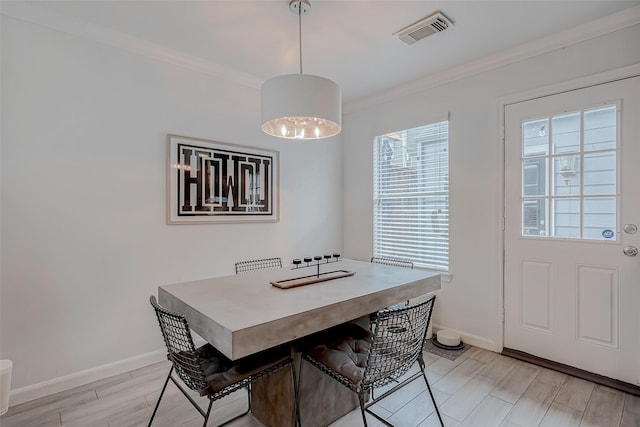 dining space with crown molding