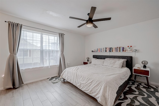 bedroom with ceiling fan and hardwood / wood-style floors