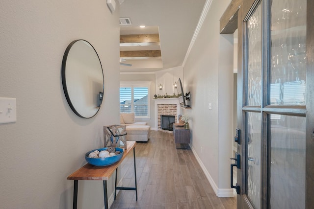 hallway with wood-type flooring and ornamental molding