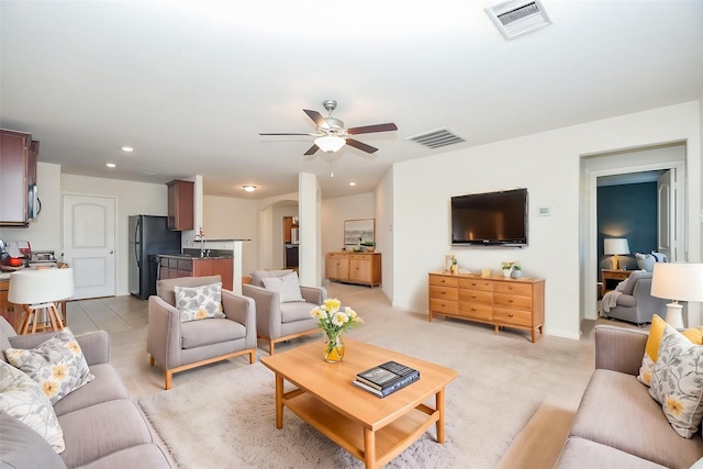 living area featuring ceiling fan, visible vents, recessed lighting, and light carpet