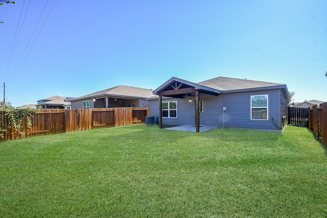 rear view of property featuring a patio, central AC unit, and a lawn