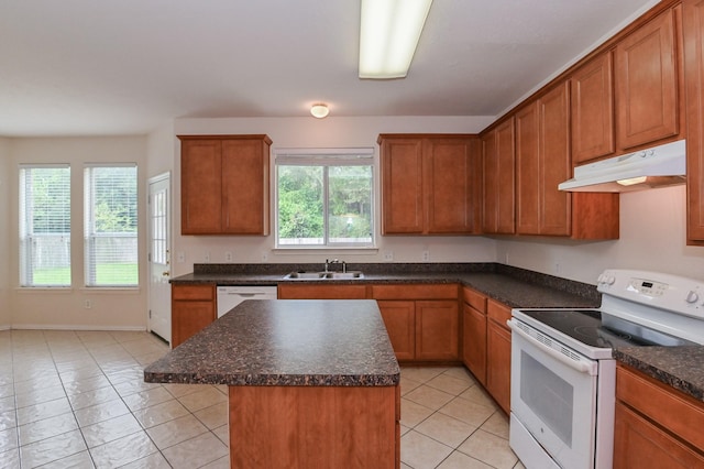 kitchen with a center island, sink, white appliances, and plenty of natural light