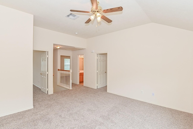 empty room featuring ceiling fan, light colored carpet, and vaulted ceiling