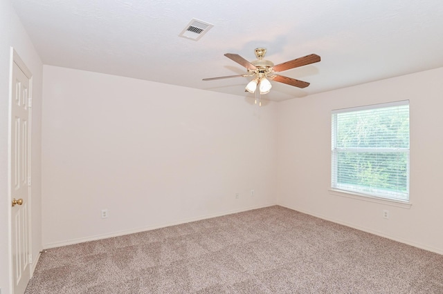 spare room featuring ceiling fan and light colored carpet