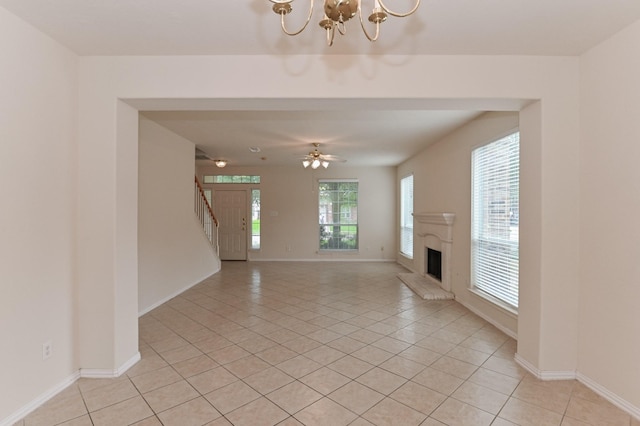 unfurnished living room featuring a healthy amount of sunlight and light tile patterned floors