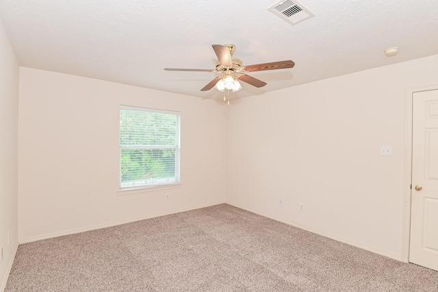 carpeted empty room featuring a textured ceiling and ceiling fan