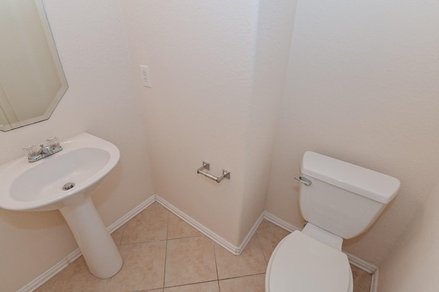 bathroom with tile patterned floors and toilet