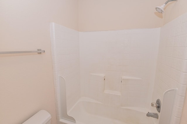 bathroom featuring toilet and  shower combination