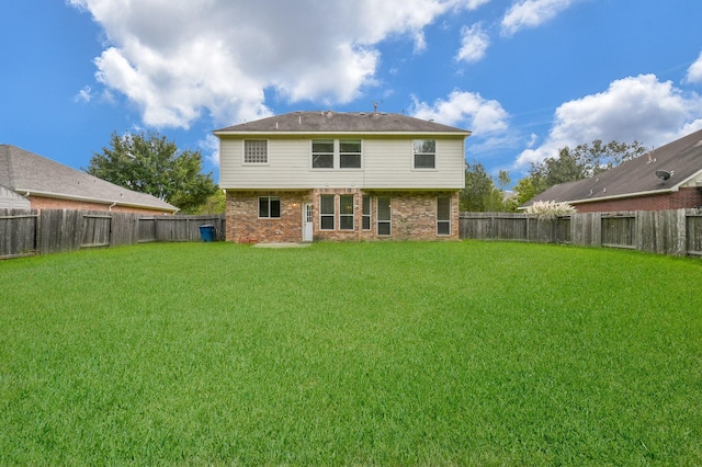 rear view of property with a yard