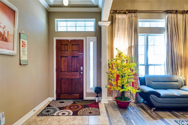 entrance foyer featuring ornamental molding and light hardwood / wood-style flooring