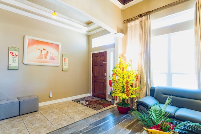 entrance foyer with crown molding and hardwood / wood-style floors