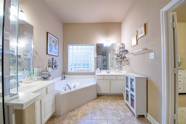 bathroom with a tub to relax in, tile patterned flooring, and vanity