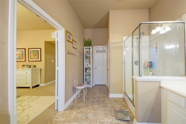 bathroom featuring an enclosed shower, vanity, and tile patterned flooring