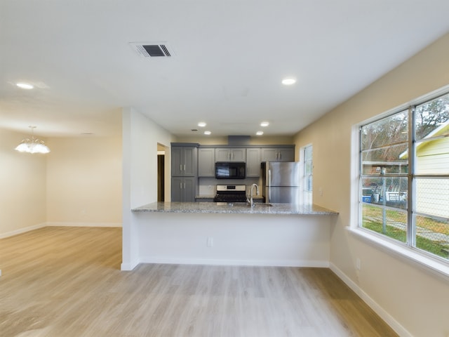 kitchen featuring stainless steel appliances, gray cabinetry, a peninsula, and visible vents