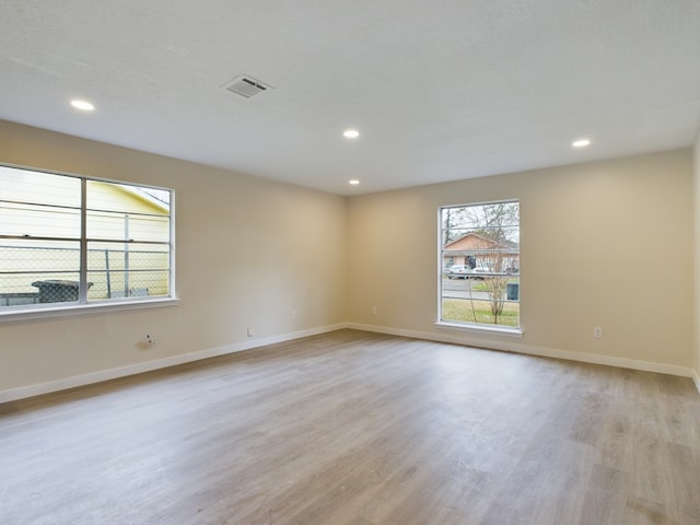 unfurnished room with recessed lighting, visible vents, baseboards, and light wood-style floors