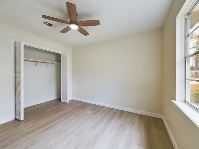 unfurnished bedroom with visible vents, baseboards, light wood-style flooring, a closet, and a ceiling fan