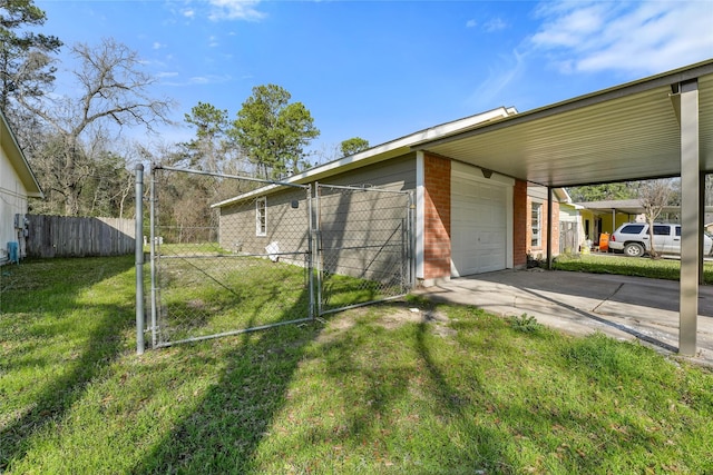 exterior space featuring an attached carport, fence, concrete driveway, and a gate