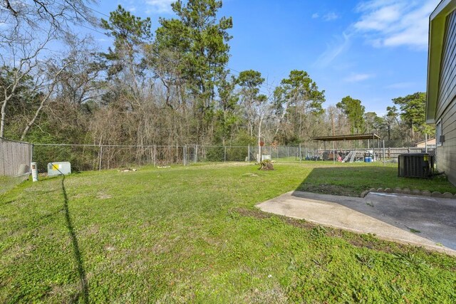 view of yard featuring central air condition unit and a fenced backyard