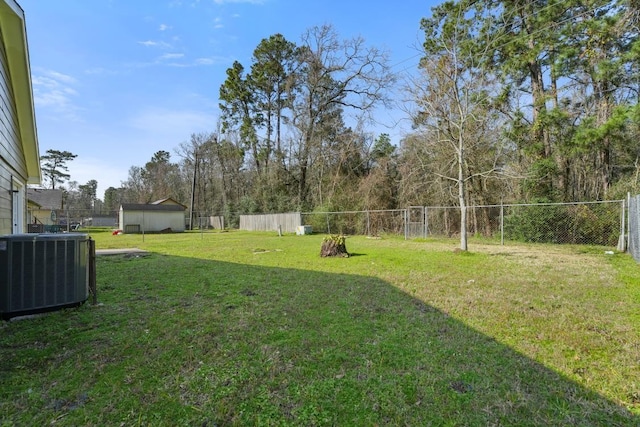 view of yard featuring central air condition unit and fence