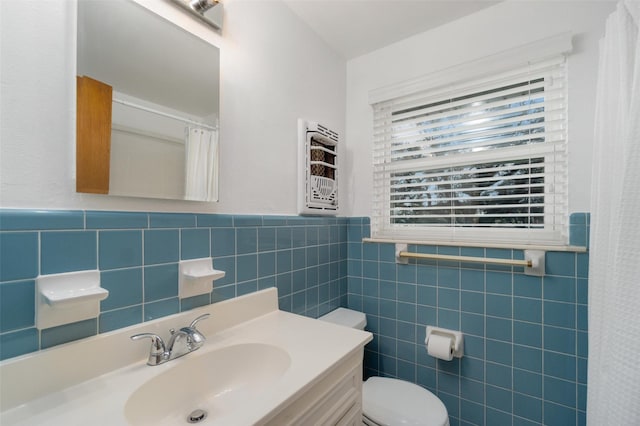 bathroom featuring tile walls, vanity, and toilet