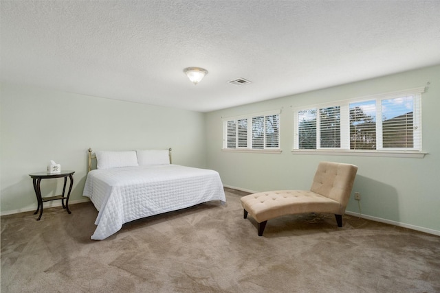 carpeted bedroom with a textured ceiling