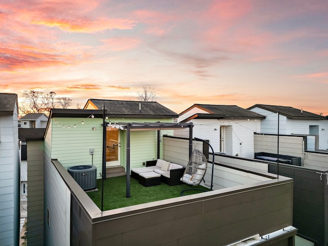 view of front facade with a balcony, an outdoor hangout area, and cooling unit