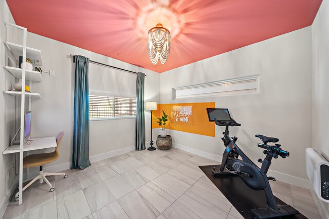 workout room featuring an inviting chandelier