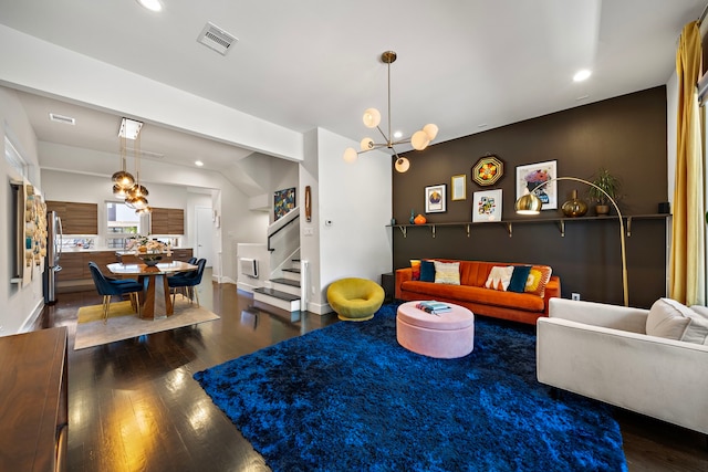 living room with dark hardwood / wood-style floors and a notable chandelier