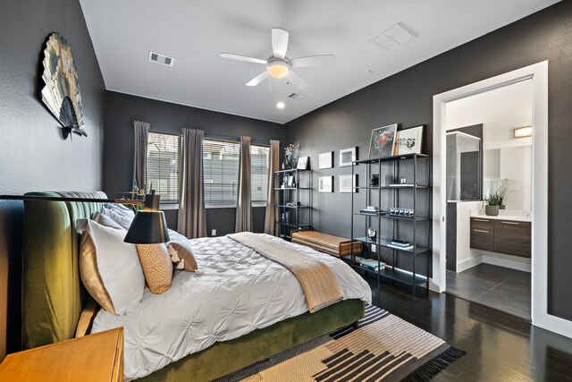 bedroom featuring ensuite bathroom, dark wood-type flooring, and ceiling fan