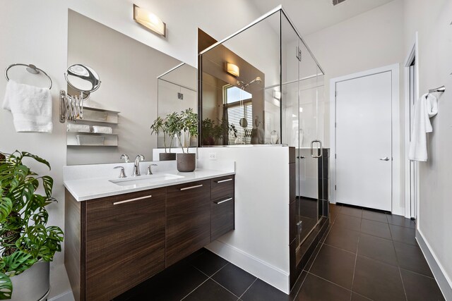 bathroom with vanity, a shower with shower door, and tile patterned floors