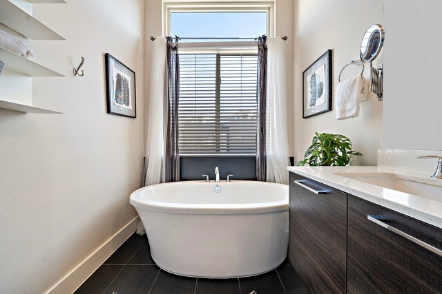 bathroom with vanity, a bath, and tile patterned flooring