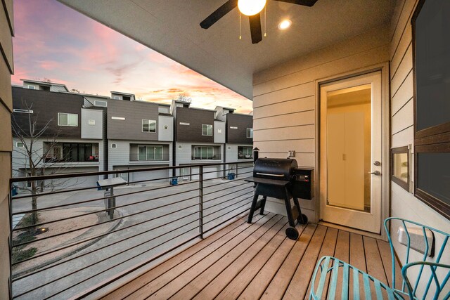 balcony at dusk featuring grilling area and ceiling fan