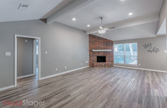 unfurnished living room featuring ceiling fan, lofted ceiling with beams, a brick fireplace, and light hardwood / wood-style flooring