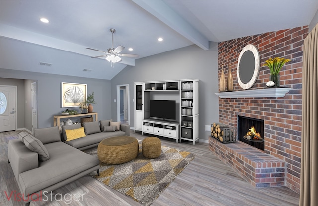 living room with lofted ceiling with beams, a brick fireplace, hardwood / wood-style flooring, and ceiling fan