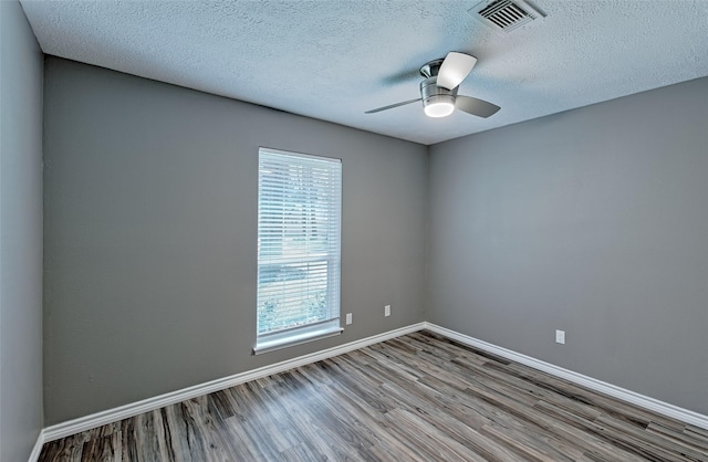 spare room featuring a textured ceiling, ceiling fan, and light hardwood / wood-style flooring