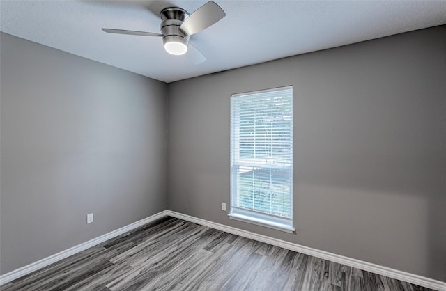 empty room featuring hardwood / wood-style flooring and ceiling fan