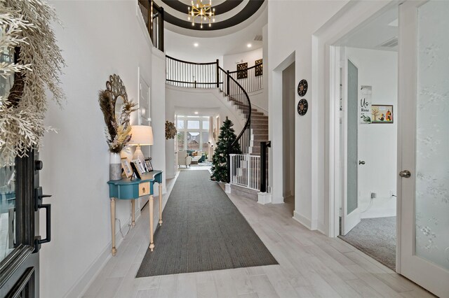 entryway with a towering ceiling and an inviting chandelier