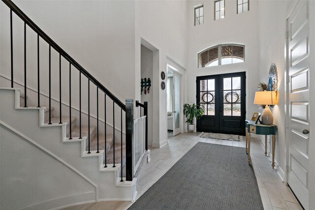 entryway with french doors and a high ceiling