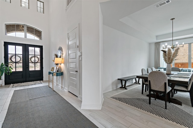 11111 Zinnias Ct, Cypress, TX 77433 - entrance foyer featuring a notable chandelier, french doors, a raised ceiling, visible vents, and a towering ceiling