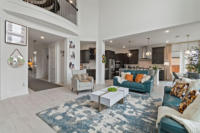 living room featuring light hardwood / wood-style floors and a high ceiling