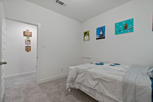 bedroom featuring light carpet