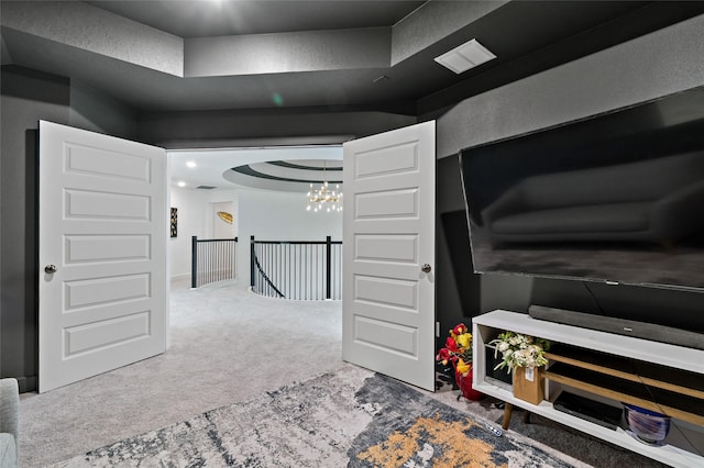 interior space featuring carpet floors and a notable chandelier