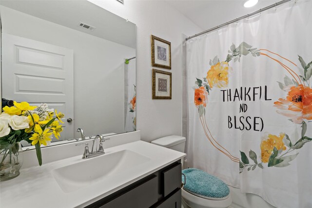 bathroom featuring vanity and toilet